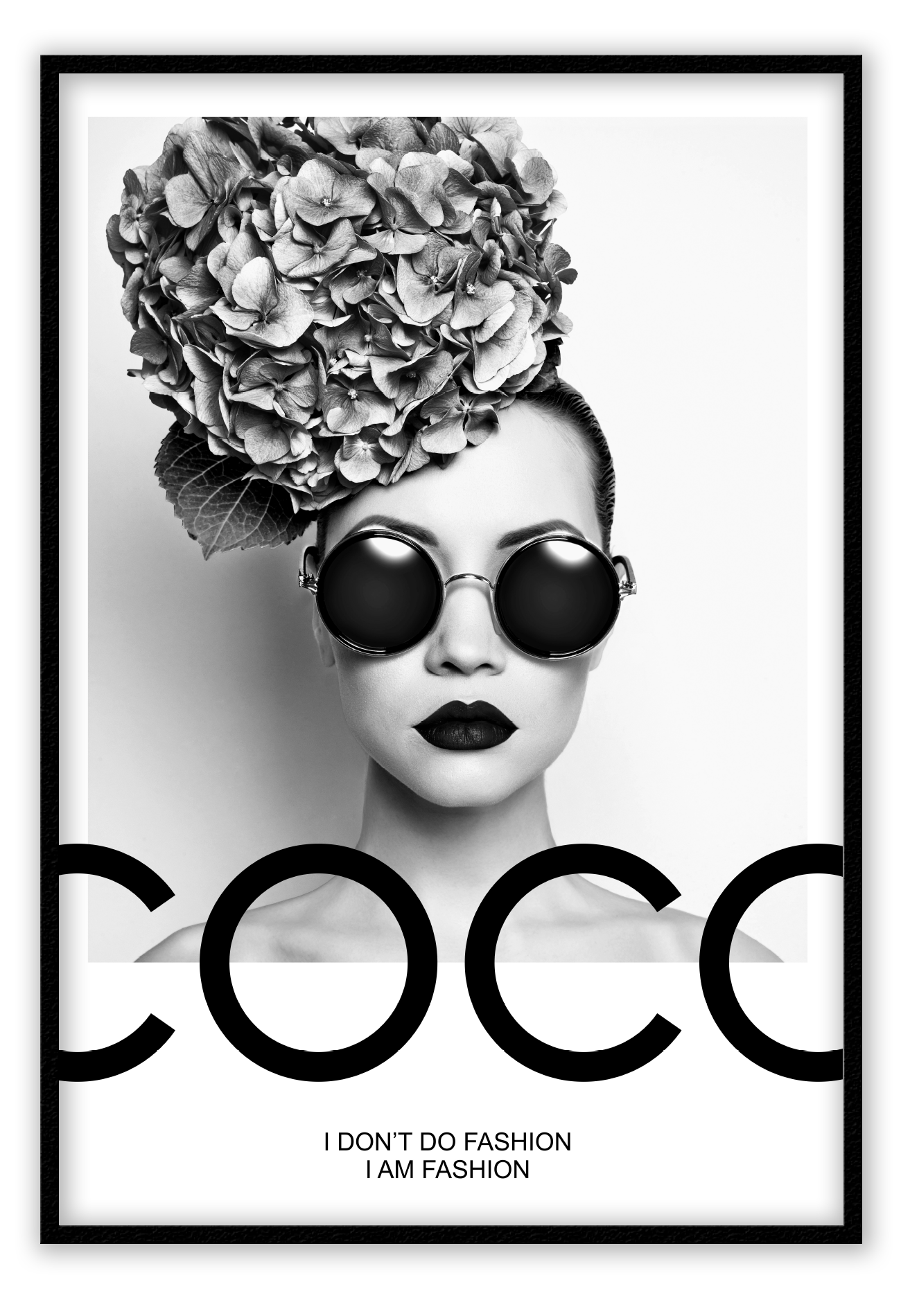 A black and white fashion photographic wall art of a lady holding balloon leaning on a scandi bike, riding on the writing coco chanel I don't do fashion I am fashion.