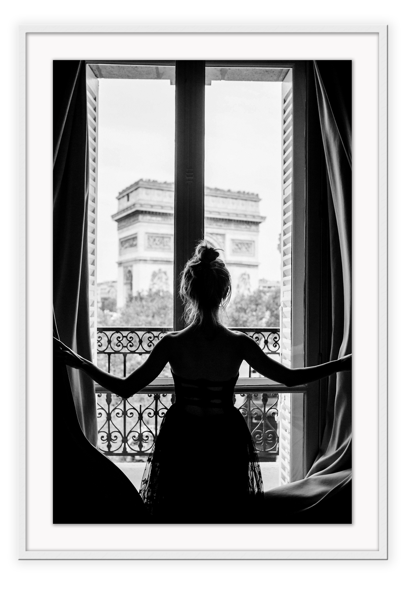 A black and white urban wall art with a girl looking out to the town from a vintage balcony in Paris.