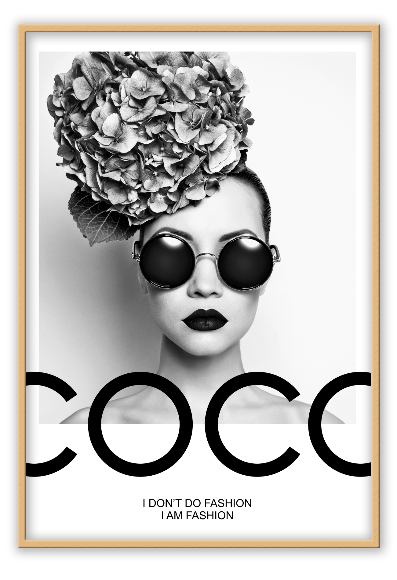 A black and white fashion photographic wall art of a lady holding balloon leaning on a scandi bike, riding on the writing coco chanel I don't do fashion I am fashion.