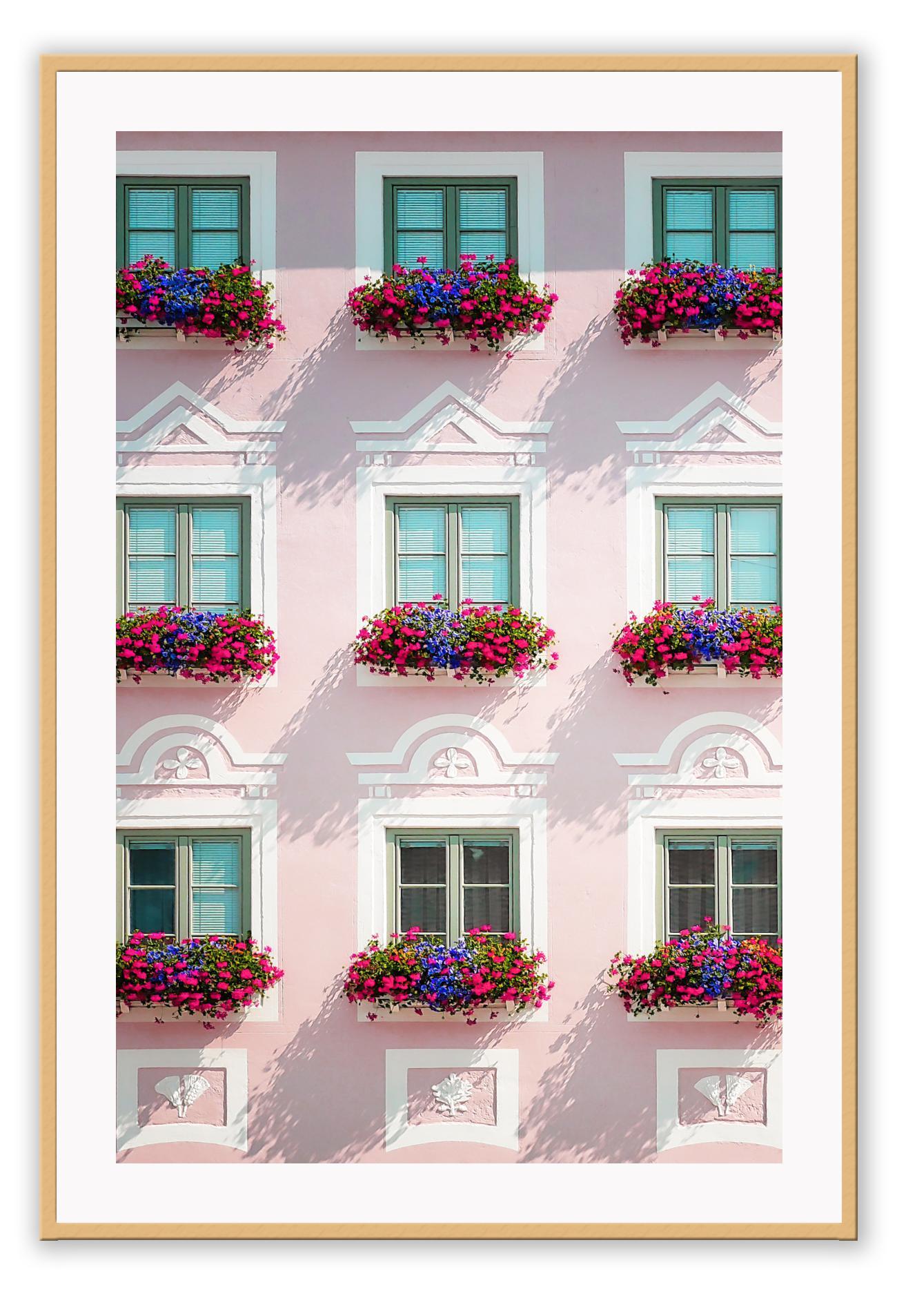 An italian architecture wall art with a pink classic European building facade and floral boutique on balconies.