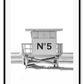 A black and white fashion wall art with black Chanel N5 fashion label on a beach cabin minimal