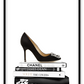 Portrait print with black and white books and high heel on the top; of the book stack