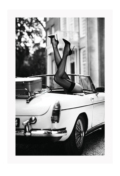 Fashion photography with womans legs coming out of a vintage car black and white lingerie sexy  