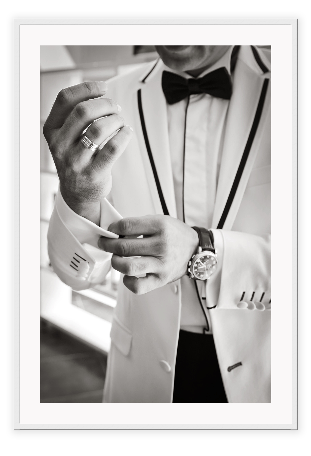 Photography fashion print man adjusting cufflinks on white suit jacket with expensive watch and bow tie 