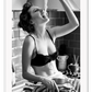 A black and white fashion wall art with a sexy lady in black lingerie eating pasta on the kitchen bench.