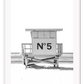 A black and white fashion wall art with black Chanel N5 fashion label on a beach cabin minimal