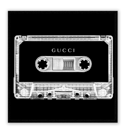A vintage fashion wall art with Gucci fashion label on 80s 90s vintage cassette tape in fluro black and white inverted colour.