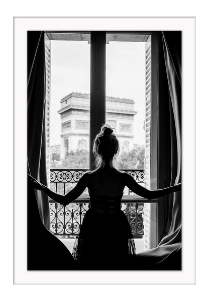 A black and white urban wall art with a girl looking out to the town from a vintage balcony in Paris. 