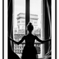 A black and white urban wall art with a girl looking out to the town from a vintage balcony in Paris. 