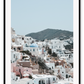 Greece, coastal architecture pastel colours blue sky mountain in background