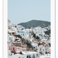 Greece, coastal architecture pastel colours blue sky mountain in background