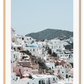 Greece, coastal architecture pastel colours blue sky mountain in background