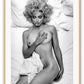 Black and white photography print with Madonna lying on a bed, nude, half covered by sheets and smoking a cigarette.