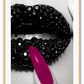 Fashion print of close-up diamond covered lips in black and white with a hot pink fingernail touching mouth