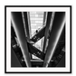 Photography print in black and white with man standing on accending escalator.