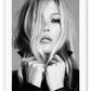 A black and white Portrait of famous celebrity model Kate Moss in leather jacket biker girl woman dark makeup blonde hair 