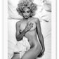 Black and white photography print with Madonna lying on a bed, nude, half covered by sheets and smoking a cigarette.